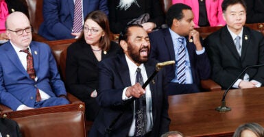 Rep. Al Green raises his cane to shout at President Donald Trump during the State of the Union.