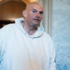 John Fetterman walks by the Senate chamber
