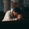 Young Man praying in Church.