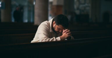 Young Man praying in Church.