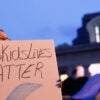 A person holds a sign reading "#TransKidsLivesMatter" outside the Ohio capitol.