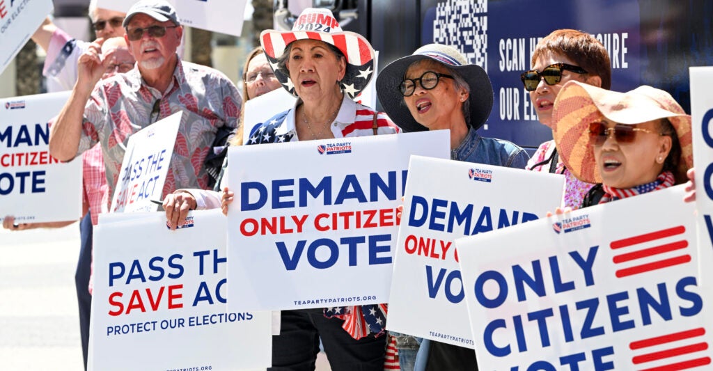 Imelda Preciado, of Garden Grove, center, joins other supporters of the SAVE Act as Tea Party Patriots Action launches a nationwide, three-week bus tour to rally support for the voting bill in Garden Grove, CA, on Monday, August 18, 2025.