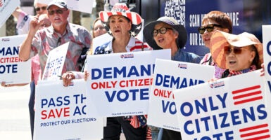 Imelda Preciado, of Garden Grove, center, joins other supporters of the SAVE Act as Tea Party Patriots Action launches a nationwide, three-week bus tour to rally support for the voting bill in Garden Grove, CA, on Monday, August 18, 2025.