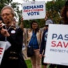 Supporters of the SAVE Act stand with their signs, including one reading, "Demand Only Citizens Vote."