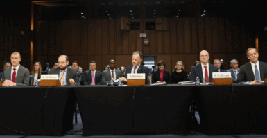 WASHINGTON, DC - FEBRUARY 10: Chris Miller, Senior Vice President & General Counsel­–Verizon Global Services, Mike Romano, former Justice Department prosecutor, Dan Schwager, counsel at Verdi & Ogletree PLLC, and David R. McAtee, senior executive vice president & general counsel at AT&T, attend a hearing on 