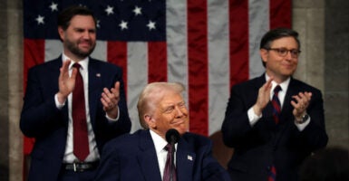 Vice President JD Vance and Speaker of the House Mike Johnson (R-LA) applaud as US President Donald Trump looks to the guests during his address to a joint session of Congress at the US Capitol in Washington, DC, on March 4, 2025.