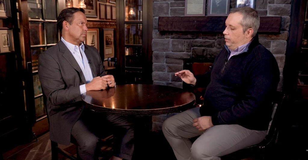 Steve Cortes sits on the left as Dr. Stephen Kleinschmit is interviewed on the right during a segment from the documentary “The Foreign Student Crisis Destroying American College Admissions.”