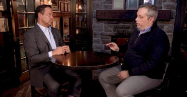 Steve Cortes sits on the left as Dr. Stephen Kleinschmit is interviewed on the right during a segment from the documentary “The Foreign Student Crisis Destroying American College Admissions.”