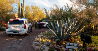 Pima County Sheriffs deputies prepare for a shift change outside of Nancy Guthrie's residence.