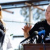 EPA Administrator Lee Zeldin speaks as SBA Administrator Kelly Loeffler looks on at a press conference in front of a destroyed school.