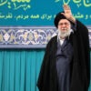 Iranian Supreme Leader Ali Khamenei waves in front of a teal background.