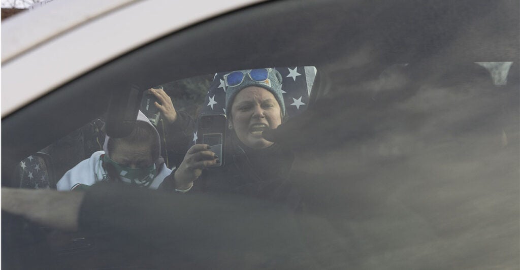 Protestors shout towards ICE Agents during a protest against U.S. Immigration and Customs Enforcement (ICE), after a U.S. immigration agent shot and killed a 37-year-old woman in her car in Minneapolis, Minneapolis, MN, U.S., January 11, 2026.
