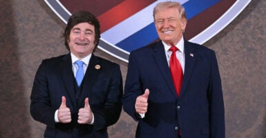 US President Donald Trump and Argentina's President Javier Milei (L) pose for a photo at the beginning of the "Shield of the Americas" Summit at Trump National Doral in Miami, Florida, March 7, 2026. President Trump is hosting a dozen right-wing leaders from Latin America and the Caribbean to discuss issues facing the region, from organized crime to illegal immigration. The summit also aims to serve Washington by boosting US interests in the region and curbing those from foreign powers like China. (Photo by SAUL LOEB / AFP via Getty Images)