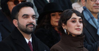 New York mayor Zohran Mamdani and his wife Rama Duwaji listen to the national anthem during his public inauguration ceremony followed by a block party at City Hall in New York on January 1, 2026. Mamdani, the young upstart of the US left, was sworn in Thursday to take over as New York mayor for a term sure to see him cross swords with President Donald Trump. After the clocks struck midnight, bringing in 2026, Mamdani took his oath of office at an abandoned subway stop to begin managing the United States' largest city. He is New York's first Muslim mayor. (Photo by TIMOTHY A.CLARY / AFP via Getty Images)