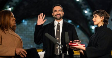 NEW YORK, NEW YORK - JANUARY 1: Zohran Mamdani is sworn in as New York City's 112th mayor by New York Attorney General Letitia James, left, alongside his wife Rama Duwaji, right, in the former City Hall subway station on January 1, 2026 in New York City. Mamdani’s term as mayor begins immediately in the new year, and a public inauguration will also take place in the afternoon at City Hall. (Photo by Amir Hamja-Pool/Getty Images)