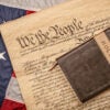 A Bible lays on a copy of the Constitution atop a flag.
