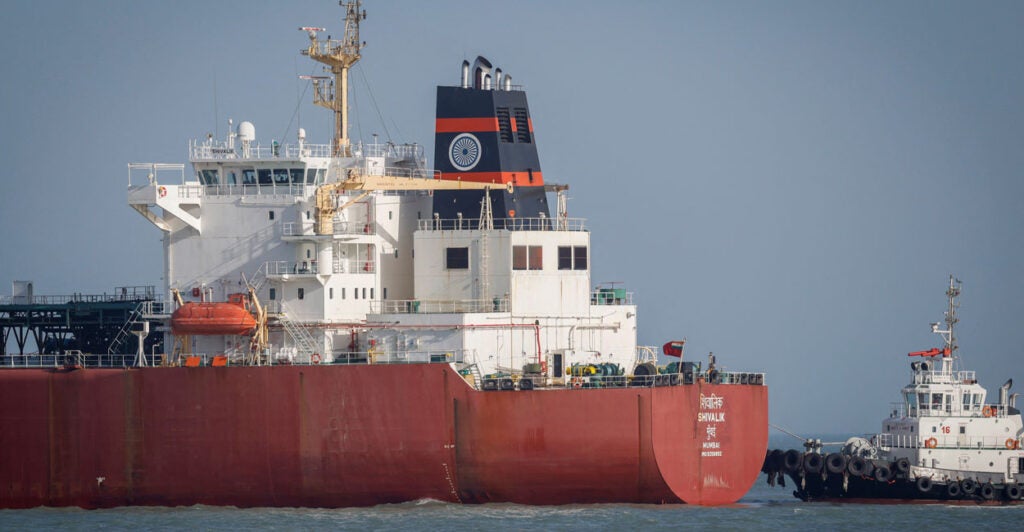 A coastguard boat approaches an Indian liquefied petroleum gas (LPG) carrier, Shivalik, as it arrives in port.