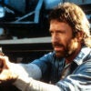 Chuck Norris points a gun in a scene from the film 'Hero And The Terror', 1988. (Cannon/Getty Images)