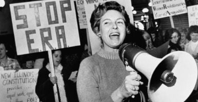 Black-and-white photo of Phyllis Schlafly, megaphone in hand, leading a rally against the Equal Rights Amendment.