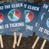 Several signs that read "The Clock is Ticking" lie in pile on the ground before Climate Emergency Day at Union Square, New York City, July 22, 2024. The text is a reminder that many believe humanity has only a few more years to make drastic changes to prevent average global temperatures from rising an additional 1.5 degrees Celsius.. (Photo by: John Senter/UCG/Universal Images Group via Getty Images)