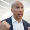 Senator Cory Booker speaks to a reporter at an ariport.