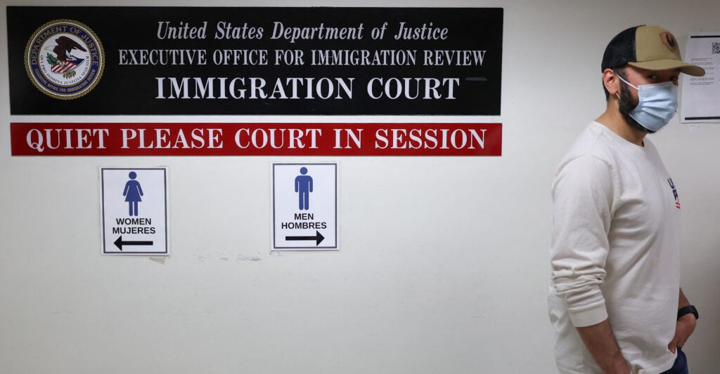 A plainclothes Immigration and Customs Enforcement (ICE) officer walks in a hallway outside of a courtroom at New York-Federal Plaza Immigration Court inside the Jacob K. Javitz Federal Building in New York City on June 6, 2025. The New York-Federal Plaza Immigration Court falls under the jurisdiction of the Executive Office for Immigration Review, a sub-agency of the US Department of Justice. US President Donald Trump has made deporting undocumented immigrants a key priority for his second term, after successfully campaigning against an alleged "invasion" by criminals. (Photo by CHARLY TRIBALLEAU / AFP) (Photo by CHARLY TRIBALLEAU/AFP via Getty Images)