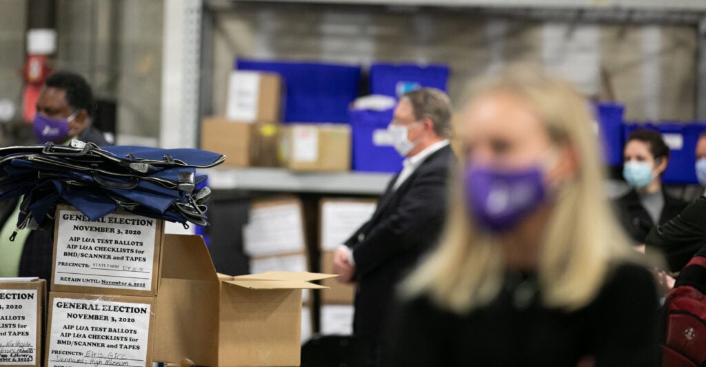 ATLANTA, GA - NOVEMBER 04: Members of an adjudication review panel look over scanned absentee ballots at the Fulton County Election Preparation Center on November 4, 2020 in Atlanta, Georgia. The 2020 presidential race between incumbent U.S. President Donald Trump and Democratic nominee Joe Biden is still too close to call with outstanding ballots to count. (Photo by Jessica McGowan/Getty Images)