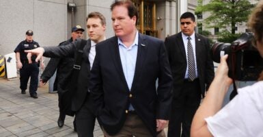 Several men in suits standing outside
