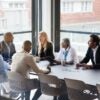 A group of people around a conference table.