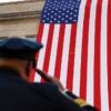 Soldier saluting an American flag.