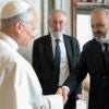 Pope Leo XIV shaking hands with Rabbi Raf Alfonso Arbib with another man standing behind