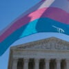Trans flag waving in front of Supreme Court.