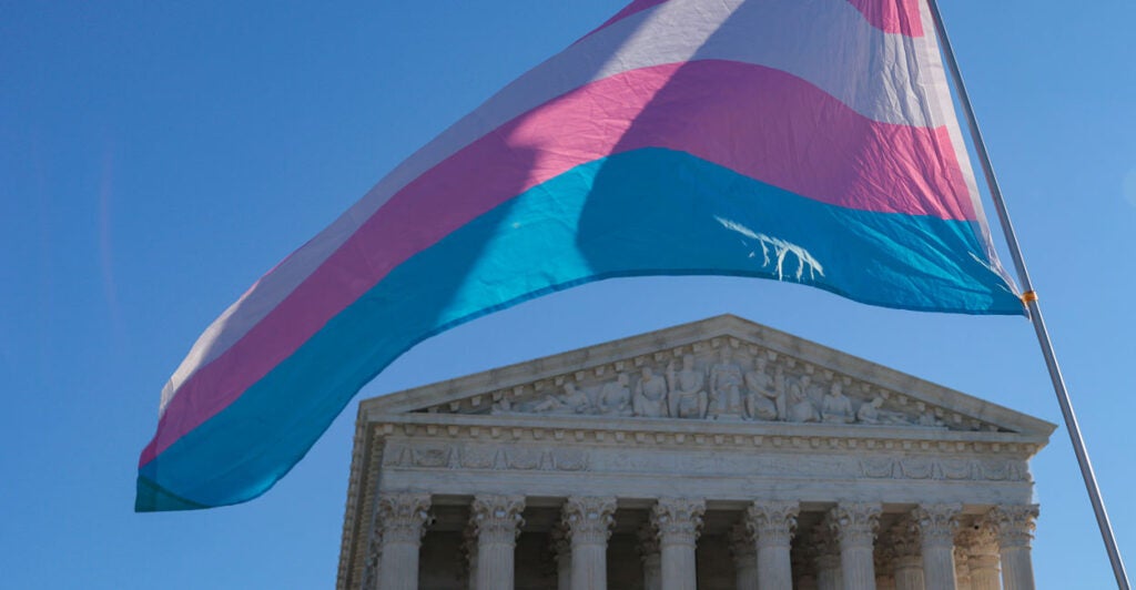 Trans flag waving in front of Supreme Court.