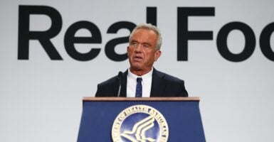 Robert F. Kennedy Jr. speaking at a podium.