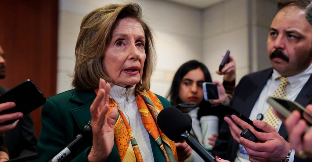Nancy Pelosi talking with reporters.