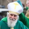 Man dressed as Saint Patrick outdoors.