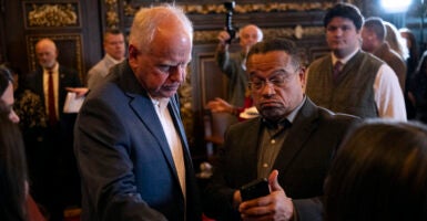 ST. PAUL, MINNESOTA - FEBRUARY 3: Minnesota Attorney General Keith Ellison (R) speaks with Minnesota Gov. Tim Walz (L) after a press conference about federal detention of children at the State Capitol building on February 3, 2026 in St. Paul, Minnesota. Trump administration officials intend to appeal a judges decision to release 5-year-old Liam Conejo Ramos who returned to Minnesota over the weekend after being held in a Texas immigration detention facility. (Photo by Stephen Maturen/Getty Images)