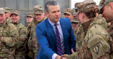 Pete Hegseth shakes hands with troops.