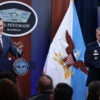 U.S. Secretary of War Pete Hegseth (L) speaks as Chairman of the Joint Chiefs of Staff General Dan Caine (R) listens during a news conference at the Pentagon on March 2, 2026.