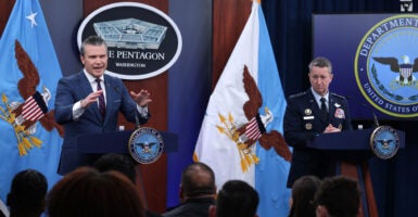 U.S. Secretary of War Pete Hegseth (L) speaks as Chairman of the Joint Chiefs of Staff General Dan Caine (R) listens during a news conference at the Pentagon on March 2, 2026.