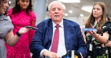 Senator Jim Justice speaks to reporters in the Capitol.