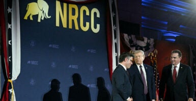 (L/R) US Speaker of the House Mike Johnson (R-LA), US President Donald Trump and NRCC chairman Richard Hudson speak as they attend the National Republican Congressional Committee fundraiser.
