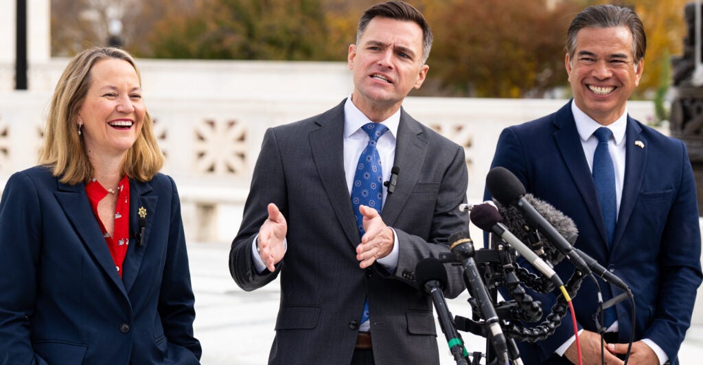 UNITED STATES - NOVEMBER 5: From left, Arizona Attorney General Kris Mayes, Oregon Attorney General Dan Rayfield, and California Attorney General Rob Bonta speak to the media following arguments on President Trump's tariffs in the U.S. Supreme Court on Wednesday, November 5, 2025. (Bill Clark/CQ-Roll Call, Inc via Getty Images)