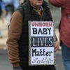 A man holds up a sign, "Unborn Babies Lives Matter: Love Life" at the March for Life.