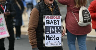 A man holds up a sign, 
