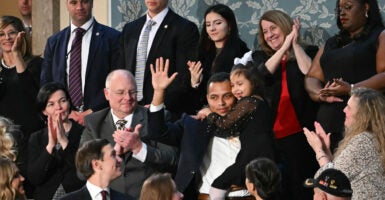 7-year-old Dalilah Coleman, held by her father Marcus Coleman as they are recognized by US President Donald Trump as he delivers the State of the Union address in the US Capitol in Washington, DC, on February 24, 2026.