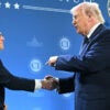President Trump shakes Speaker Johnson's hand at Doral Florida Republican retreat.