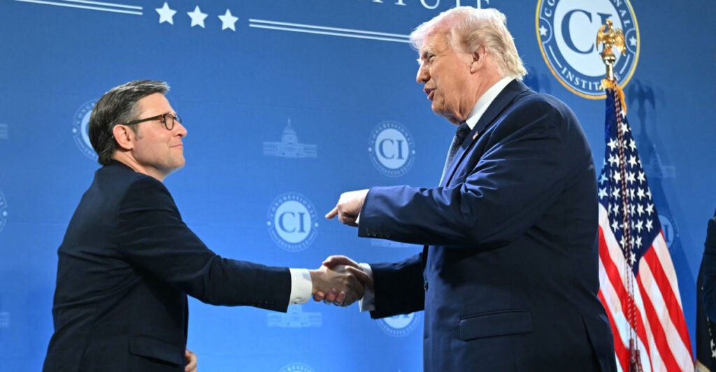 President Trump shakes Speaker Johnson's hand at Doral Florida Republican retreat.