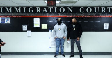 Masked federal agents stand in a hallway at the New York Federal Plaza Immigration Court inside the Jacob K. Javitz Federal Building in New York on March 5, 2026. US President Donald Trump has made deporting undocumented immigrants a key priority for his second term, after successfully campaigning against an alleged 
