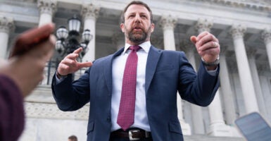 Markwayne Mullin speaks to reporters outside the capitol.